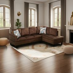 a living room filled with furniture and a fire place in front of two windows on the wall