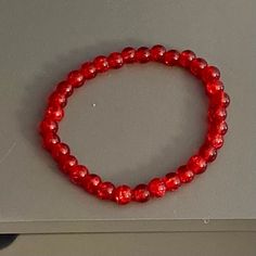 This is a beaded bracelet, made of 6mm acrylic crackle beads in the shade cherry red. The bracelet is stretchy (no clasp) with an approximate circumference of 7 inches.  Thanks for visiting my shop. Please message me if you have any questions! Casual Red Stretch Bracelet As A Gift, Casual Red Stretch Bracelet For Gift, Casual Red Stretch Bracelet As Gift, Hypoallergenic Red Beaded Bracelets With Round Beads, Hypoallergenic Red Beaded Bracelets, Red Resizable Bracelet Jewelry, Adjustable Red Bracelet With Large Beads, Red Stretch Bracelet With 8mm Beads, Casual Red Round Stretch Bracelet