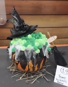 a decorated pumpkin sitting on top of a table