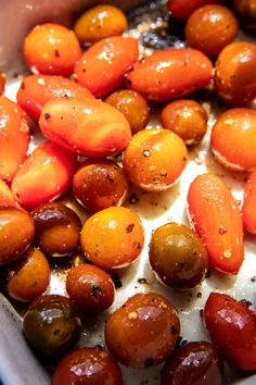 tomatoes and olives are being cooked in an oven