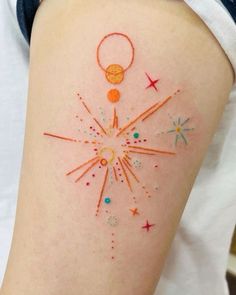 a woman's arm with an orange and red tattoo design on her left thigh