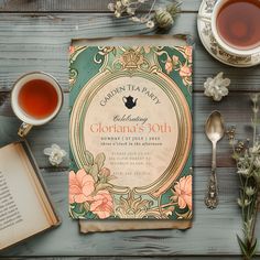 an open book next to two cups of tea and spoons on a wooden table