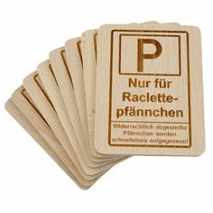 four wooden coasters with german words on them, one is for parking and the other has