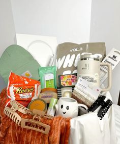 a basket filled with lots of items on top of a bed