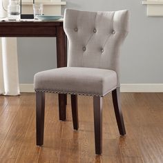 a dining room chair sitting on top of a hard wood floor