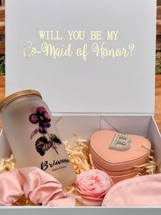 an open box with some pink flowers and other items in it that says, will you be my g - maid of manor?