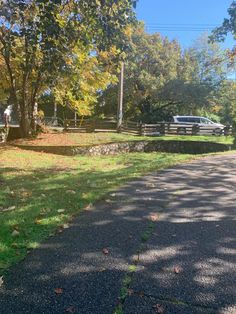 an empty road in the middle of a park