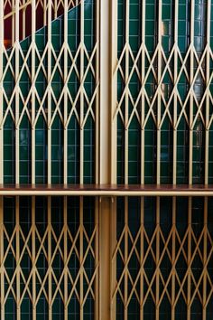 the side of a building with green tiles on it