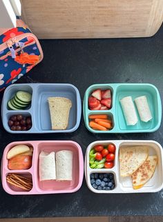 four plastic containers filled with different types of food