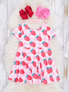 Our swing dress silhouette is here again in this sweet strawberry print! 🍓 Just in time for warm weather, this dress boasts a pink gingham background and is covered in yummy strawberries. Your little one will be the pick of the patch! Fits true to size. 95% Polyester / 5% Spandex Accessories sold separately. Suggest bow color #37 and #53 Import. **Afterpay and Sezzle Purchase Requires $35 Minimum Order. Pink Gingham Background, Ruffle Pants Outfit, Matching Sister Outfits, Gingham Background, Matching Sibling Outfits, Outfits Matching, Ruffle Outfit, Xxxl Dress, Sibling Outfits