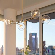 a dining room table and chairs in front of large windows with city skyline outside the window