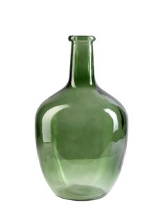 a green glass vase sitting on top of a table