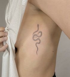 a woman with a snake tattoo on her chest