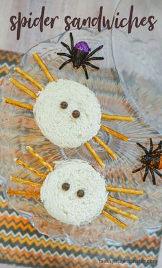 two spider sandwiches sitting on top of a glass plate