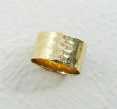 a close up of a gold ring on a white surface