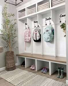 the entryway is decorated with white benches and coat racks for coats, shoes, and backpacks