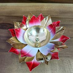 a red and white flower shaped metal object