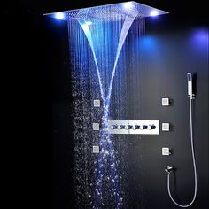 the shower head is illuminated with blue lights and water running down it's side