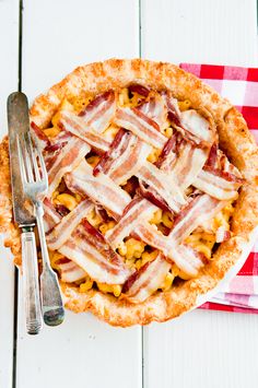 a close up of a pie on a table with a fork and knife next to it