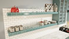 the shelves in the kitchen are filled with dishes and cups, along with empty glasses