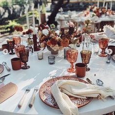 the table is set with plates, silverware and napkins for an elegant dinner