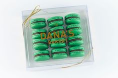 a box of green macaroons with the words dana's bakery on them