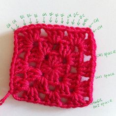 the crochet square is made up of red yarn