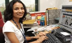 a woman sitting in front of a computer keyboard