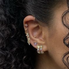 a close up of a person's ear with two piercings on top of it