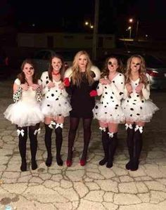 four girls dressed in costumes posing for the camera