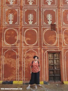 a woman standing in front of an old building