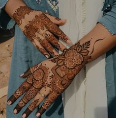 two hands with henna designs on them