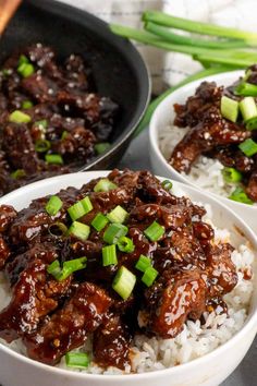 three white bowls filled with meat and rice on top of a wooden table next to green onions