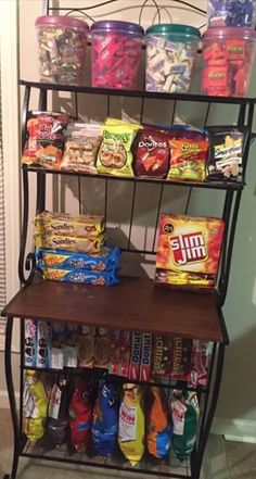 a shelf filled with lots of snacks and candy bars on top of it's shelves