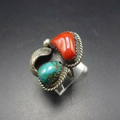 ". VINTAGE NAVAJO RING DESCRIPTION: This exquisite ring features substantial specimens of blue-green turquoise and old red Mediterranean coral. The gemstones are secure in serrated bezel, embellished with twisted silver, applied raindrop, and applied leaf. This beautiful ring will be a treasured addition to your collection of fine vintage Native American jewelry. MEASUREMENTS: Ring face measures 1 1/8\" x 3/4\" Turquoise Cabochon measures 11mm x 7mm RING SIZE: 5 3/4 WEIGHT: 8.4 grams SIGNED: no Southwestern Style Red Ring Jewelry, Vintage Multi-stone Turquoise Ring Gift, Southwestern Multi-stone Rings For Anniversary, Vintage Turquoise Rings With Natural Stones, Vintage Multicolor Multi-stone Turquoise Ring, Southwestern Gemstone Rings For Collectors, Multicolor Adjustable Vintage Rings, Adjustable Multicolor Vintage Rings, Adjustable Vintage Turquoise Ring With Natural Stones