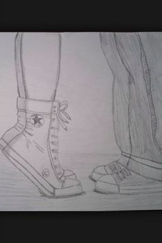 a pencil drawing of two feet with shoes on the ground next to eachother