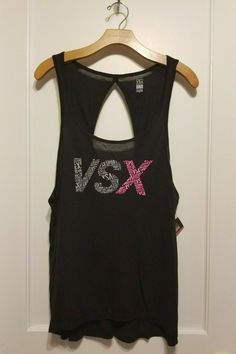 Victoria's Secret VSX SPORT Graphic Print Tank Top Black 100% Modal, Size L, NWT Color: Black Tank straps. Scoop neckline. Back cutout. VSX gray/pink graphic print in front. Relaxed fit. 100% Modal. Machine wash. Imported. Approximate measurements: length 27" front, 29" back, chest 19.5". Final sale. No returns please. From a smoke and pet free environment. I combine shipping. Thank you! Black Logo Print Tank Top For Summer, Pink Stretch Activewear With Graphic Print, Sporty Black Scoop Neck Top, Logo Print Gym Tops, Black Sleeveless Graphic Print Activewear, Black Sleeveless Activewear With Graphic Print, Black Graphic Print Scoop Neck Top, Black Graphic Print Top With Scoop Neck, Black Scoop Neck Top With Graphic Print