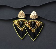 Very elegant beaded earrings! Matched to this bracelet https://www.etsy.com/listing/1658634952/black-and-gold-wide-cuff-bracelet-bead?click_key=bc8702ea4f5fa6c65243fe4ad47119b605ad03fb%3A1658634952&click_sum=d8bea719&ref=shop_home_active_1&cns=1 The intricate bead embroidery combines the sophistication of black with the radiant shimmer of gold, creating a captivating contrast that will turn heads. Matted bugle seed beads, meticulously hand-stitched, forming delicate pattern. Gold accents, sparkling like scattered stardust, adding a touch of glamour and luxury. Lightweight and comfortable, perfect for day or night wear. Trilliant shape is very dramatic! These earrings are perfect for: The fashion-forward woman who appreciates unique and handcrafted pieces. Adding a touch of elegance to ever Luxury Gift Beaded Dangling Earrings, Luxury Gold Beaded Earrings For Women, Luxury Beaded Dangle Earrings, Traditional Luxury Beaded Earrings For Gift, Luxury Gold Beaded Earrings, Luxury Handmade Party Beaded Earrings, Luxury Handmade Beaded Earrings, Luxury Beaded Dangling Earrings As Gift, Luxury Beaded Earrings For Evening