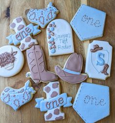 decorated cookies are arranged on a wooden table