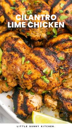 grilled chicken with cilantro and lime garnishes on the side