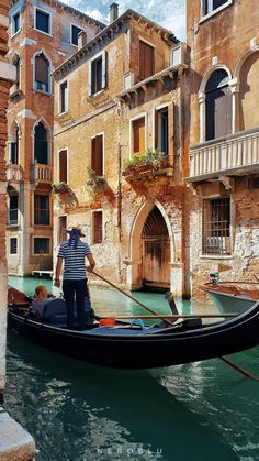 a gondola with two people in it on the water