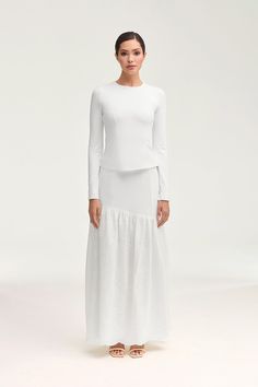 Indulge in the effortlessly chic Madelyn White Eyelet Maxi Skirt. Crafted from delicate eyelet fabric with breezy, princess seams and contrasting tiered detailing, this skirt is the epitome of luxury. Elevate any look with this exclusive piece that exudes elegance and sophistication. Model is 5'7" and is wearing size XS. Eyelet Maxi Skirt, White Dress Formal, Dresses Flowy, Nikkah Dress, Hijab Pins, Eyelet Fabric, Sheer Skirt, Engagement Dresses, Princess Seams