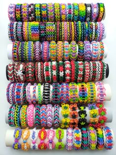 many different colored bracelets stacked on top of each other