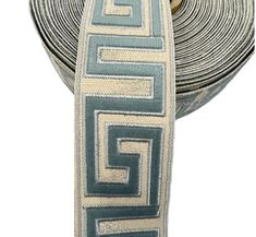 a close up of a tie that is on a white surface with blue and beige stripes