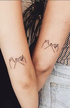 two people with matching tattoos on their arms