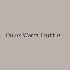 the words dulux warm truffle on a gray background