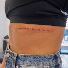 the back of a woman's stomach with an inscription on it that reads, we become the love she deserves