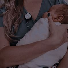 a woman holding a baby in her arms with a stethoscope on it