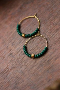 Lovely beaded earrings with green glass seed beads, gold plated stainless steel beads and gold tone stainless steel round hoop earrings. Earring hooks are from nickel free and lead free metal. Perfect jewelry for everyday wear or a great gift for someone special! Diameter of hoops is 25 mm Other earrings of my shop you can see here: https://www.etsy.com/shop/NaTavelli?section_id=13757927 Thanks for visit. Brass Beaded Hoop Earrings As Gift, Beaded Brass Hoop Earrings For Gift, Green Round Jewelry With Tiny Beads, Green Jewelry With Tiny Beads, Green Small Hoop Beaded Earrings With Tiny Beads, Green Dangle Hoop Earrings With Tiny Beads, Green Small Hoop Earrings With Tiny Beads, Green Hoop Earrings With Tiny Beads, Green Tiny Beads Small Hoop Jewelry