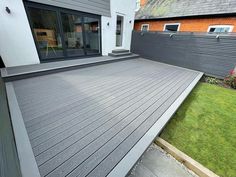 a large wooden deck in front of a house